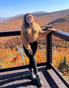 Picture of Yhanelly Ruiz standing on platform in front of autumn mountain landscape