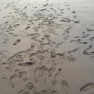 shoe prints on a sand beach